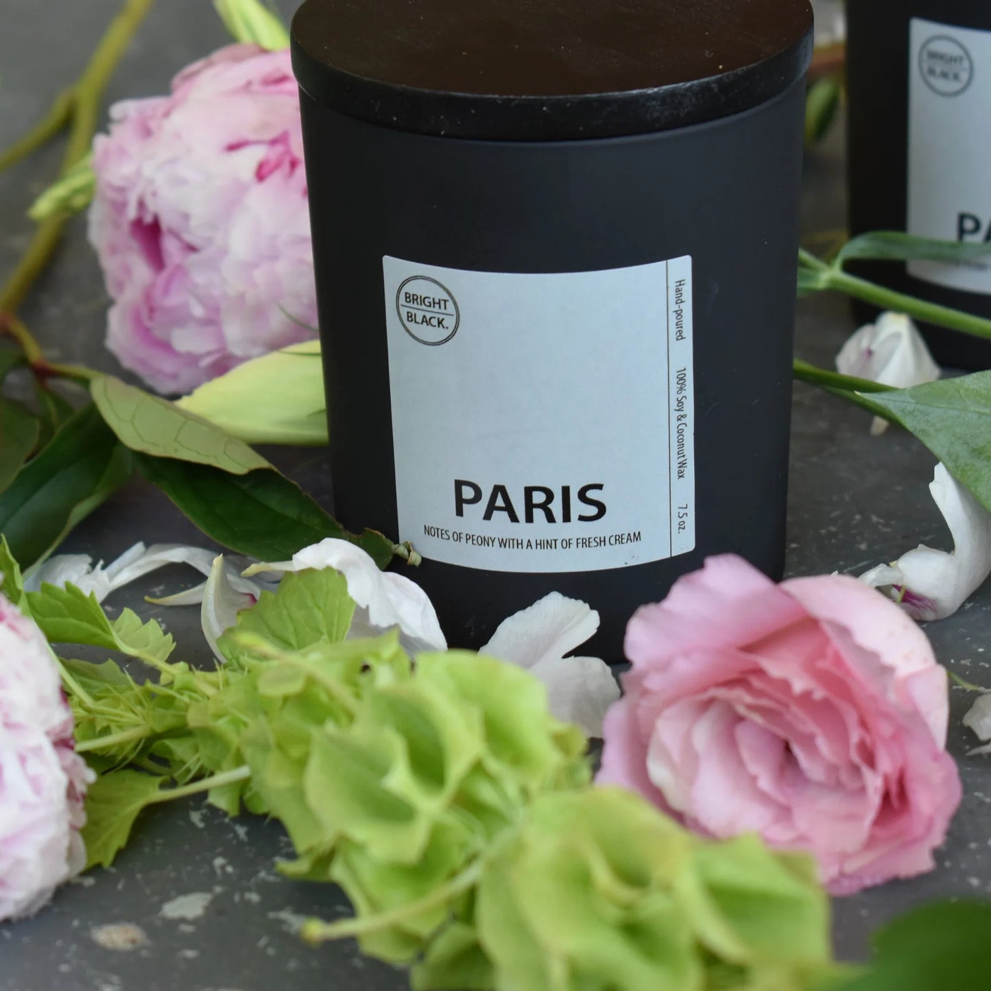 Bright Black Candles in Black Frosted Glass vessel, featuring a floral blend of peony and gardenia with a hint of French crème brûlée. 4.75oz candle with natural wooden wicks, 70-80 hours of burn time. Uplifting scents and minimalistic design.