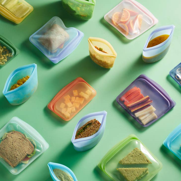 Stasher reusable silicone bags and bowls in sandwich (7.5 x 7 in), bowl (2-cup, 7.5 x 5 in), snack (7.5 x 4.5 in), and stand-up mini (8.5 x 7 x 3.5 in) sizes. Leakproof, plastic-free, and microwave-safe—perfect for meal prep, food storage, and travel.
